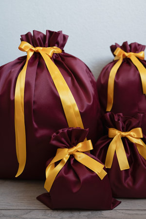 Christmas presents wrapped in red paper and tied with gold ribbons.の写真素材