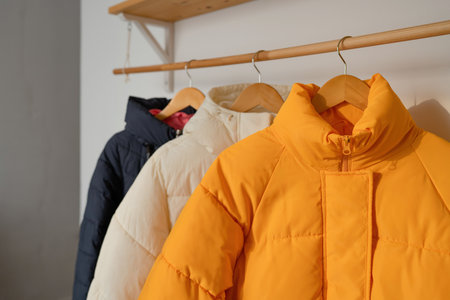 Stylish winter jacket on hanger in dressing room, closeupの写真素材
