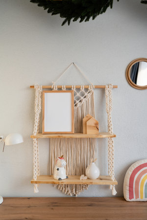 Wooden shelves with mock up photo frame hanging on the wall.の写真素材