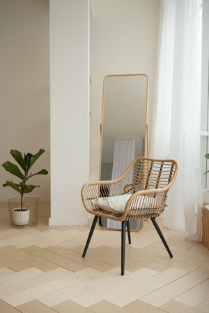 Wicker rattan armchair and mirror in living room at homeの写真素材