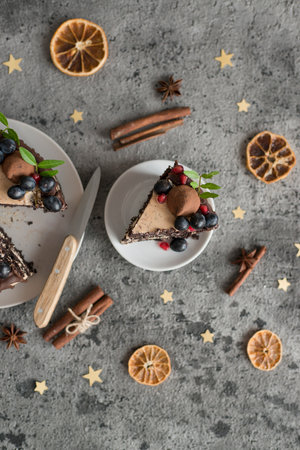 Delicious chocolate cake with berries and cinnamon on gray table, flat layの写真素材