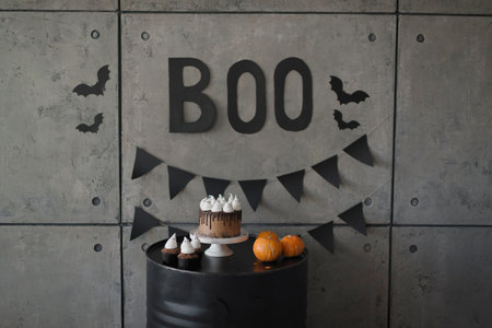 Halloween cake with pumpkin and bat decoration on concrete wall background.の写真素材
