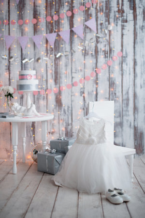 Child dress and shoes on the background of a wooden wallの写真素材