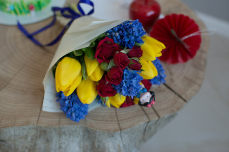Bouquet of colorful flowers on a wooden tableの写真素材