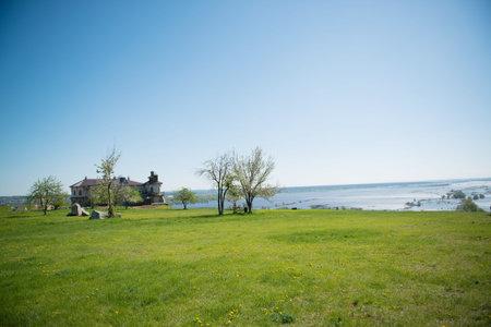 Spring landscape with a house on the bank of the riverの写真素材