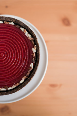 Close up of a red velvet cake on a white plate on a wooden backgroundの写真素材