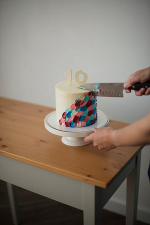 Birthday cake with number 10 candle and a knife on a table