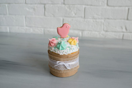 Easter cake on a wooden table, white brick wall in the backgroundの写真素材