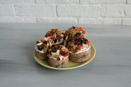Cupcakes with dried fruits and nuts on a light background.の写真素材