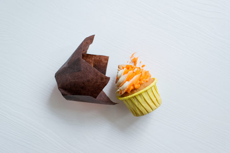 Cupcake with cream in paper box on white background