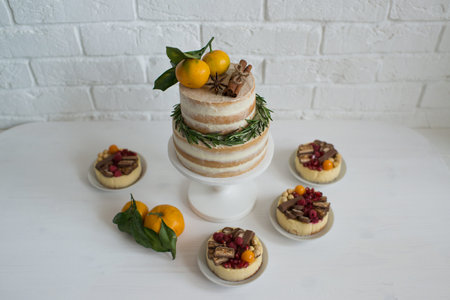 Gift boxes on white wooden table against white brick wall background.
