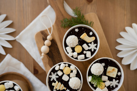 Chocolate with marshmallows in cups on a wooden background. top view.の写真素材