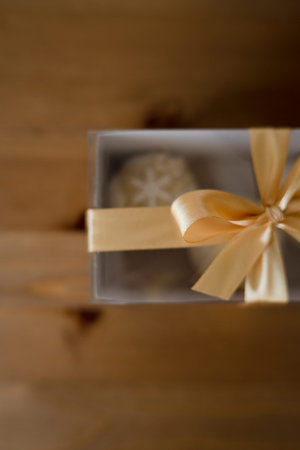 Gift box with bow on wooden background. selective focus.