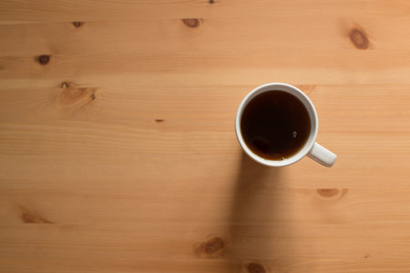 Coffee cup on wooden table with copy space, top viewの写真素材