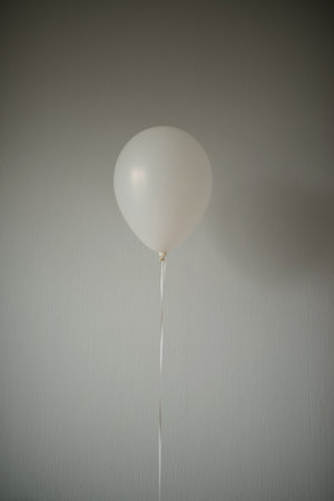 White balloon on a white wall background. Copy space for text.の写真素材