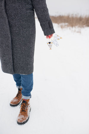 Close-up of a woman in winter clothes in the winter forest.の写真素材