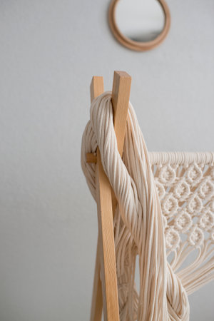 Close up of a white yarn hanging on a wooden hangerの写真素材