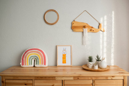 Interior of children's room with wooden chest of drawers and accessoriesの写真素材