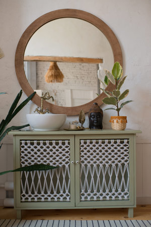 Interior of a bathroom with a mirror and a plant in a pot