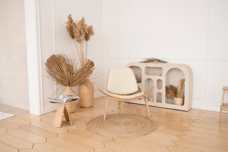 Modern living room with white chair and rattan basket on wooden floorの写真素材