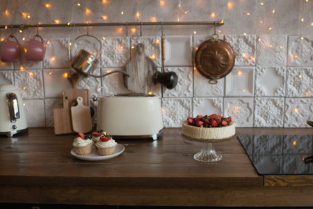 Delicious homemade cake with fresh strawberries on a wooden table in the kitchen