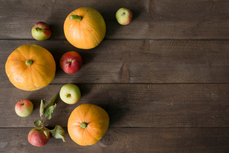 Autumn still life with pumpkins and apples on a wooden backgroundの写真素材