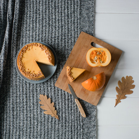 Pumpkin pie on a gray knitted plaid, top viewの写真素材