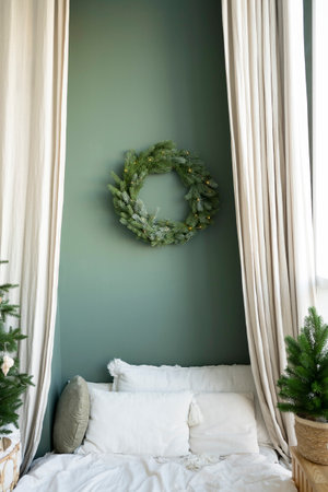Christmas wreath on the wall in the bedroom with green walls.の写真素材