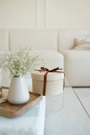 Gift box and flowers on the table in the living room.