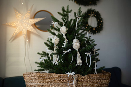 Christmas tree in a wicker basket on the background of a garland