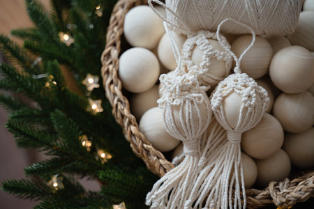Basket with white Christmas balls and garland on the background of a Christmas treeの写真素材