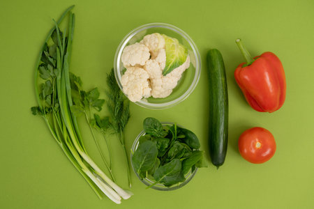 Fresh vegetables on green background. Healthy food concept. Top view.の写真素材