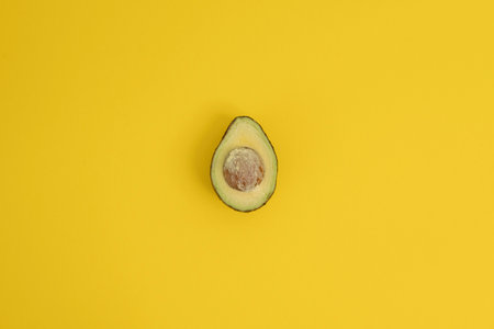 Avocado on a yellow background. Top view. Flat lay.の写真素材