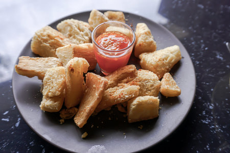A delicious snack of boiled sweet potato and sambal.