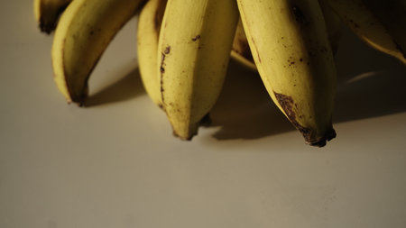 Bunch of bananas on a white table. Selective focus. Close up.の写真素材