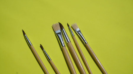 Paintbrushes on a green background. Paint brushes on a green background.