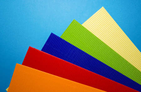corrugated coloured cardboard on a blue backgroundの写真素材