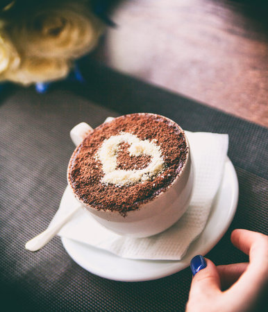 Filming by a close up of the hands holding warm coffee. Newlyweds have coffee.の写真素材