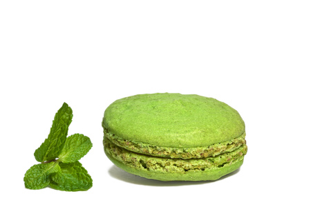 colorful macaroon cookies green with mint leaf on white backgroundの写真素材
