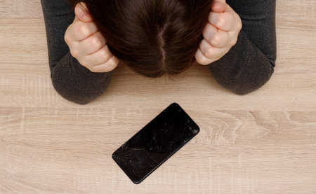 broken iphone smartphone upset girl because of the screen smartphone display in cracks