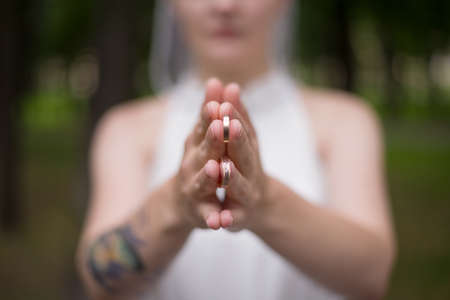 the bride holds the wedding rings in her hands close-up. Wedding accessories. wedding photo. marriage registry,の写真素材