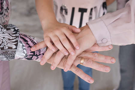 Hands of generations grandmother mom daughter, family trust love careの写真素材