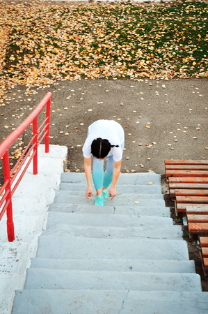 Active girl with excess weight is going to go in for sports to lose weight at the stadium. Healthy lifestyle.の写真素材