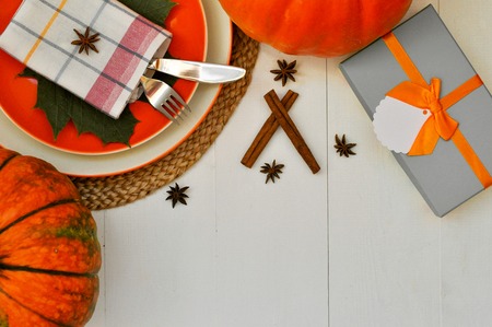 Beautiful dining table setting for thanksgiving theme and beautiful fall card in white and orange colors. flatlayの写真素材