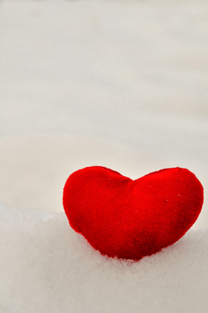 Valentine's day and Love composition with red plush heart on snow. Healthy lifestyle concept. close up. copy spaseの写真素材