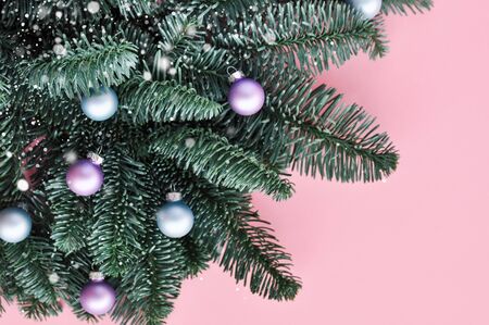 Christmas tree with pink, blue, beige balls of pastel trending tones on pink background. top viewの写真素材