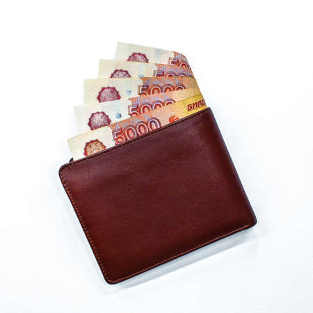 Five thousand rubles banknotes in the brown leather wallet on white background. Russian cash money.の写真素材