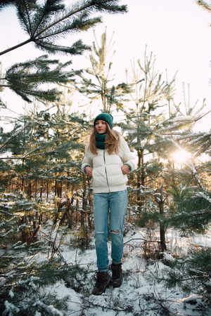 beautiful young woman in the winter forestの写真素材
