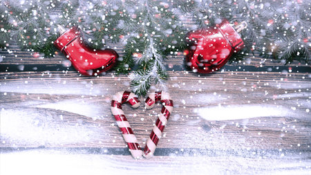 Snowy Christmas background with fir branches and toys on a wooden background. place for text.の写真素材