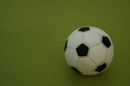 A black and white football on the green foneの写真素材
